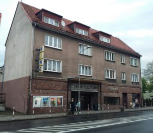 Kamienica dwupiętrowa w ścianei frontowej wejście do kina oraz kawiarni